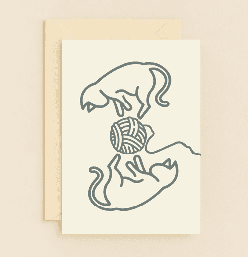 Delight someone special with a charming "Thinking of You" card featuring playful cats and a yarn ball, perfect for cat lovers who appreciate whimsical humor.