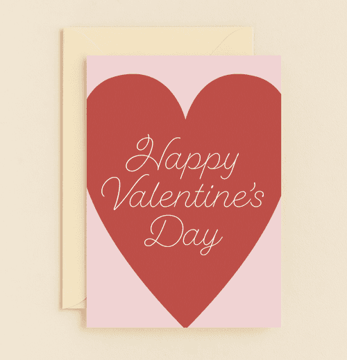 Celebrate Valentine's Day with a simple yet elegant card featuring a heartfelt red heart and cursive wishes on a soft pink backdrop.