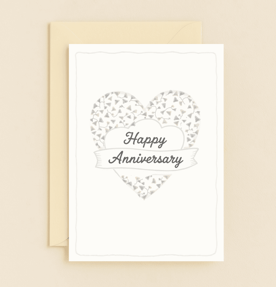 Celebrate your timeless love with this elegant anniversary card, featuring a heart adorned with abstract leaves and a graceful ribbon banner.