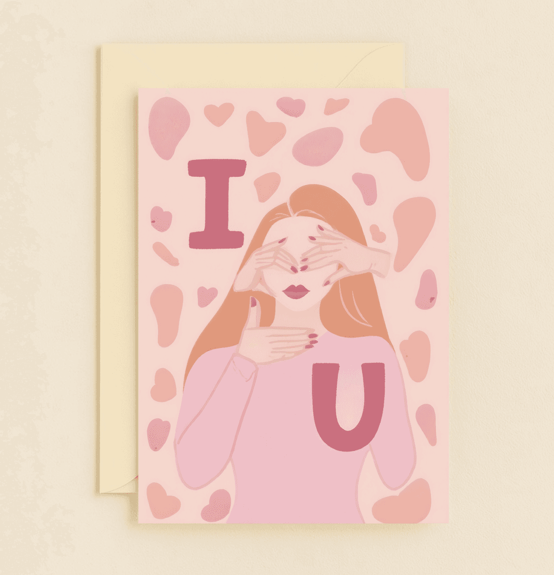Celebrate your anniversary with "Hidden Love, Revealed Joy," a playful card featuring heart shapes and finger hearts, expressing "I Love You" in warm pink hues.