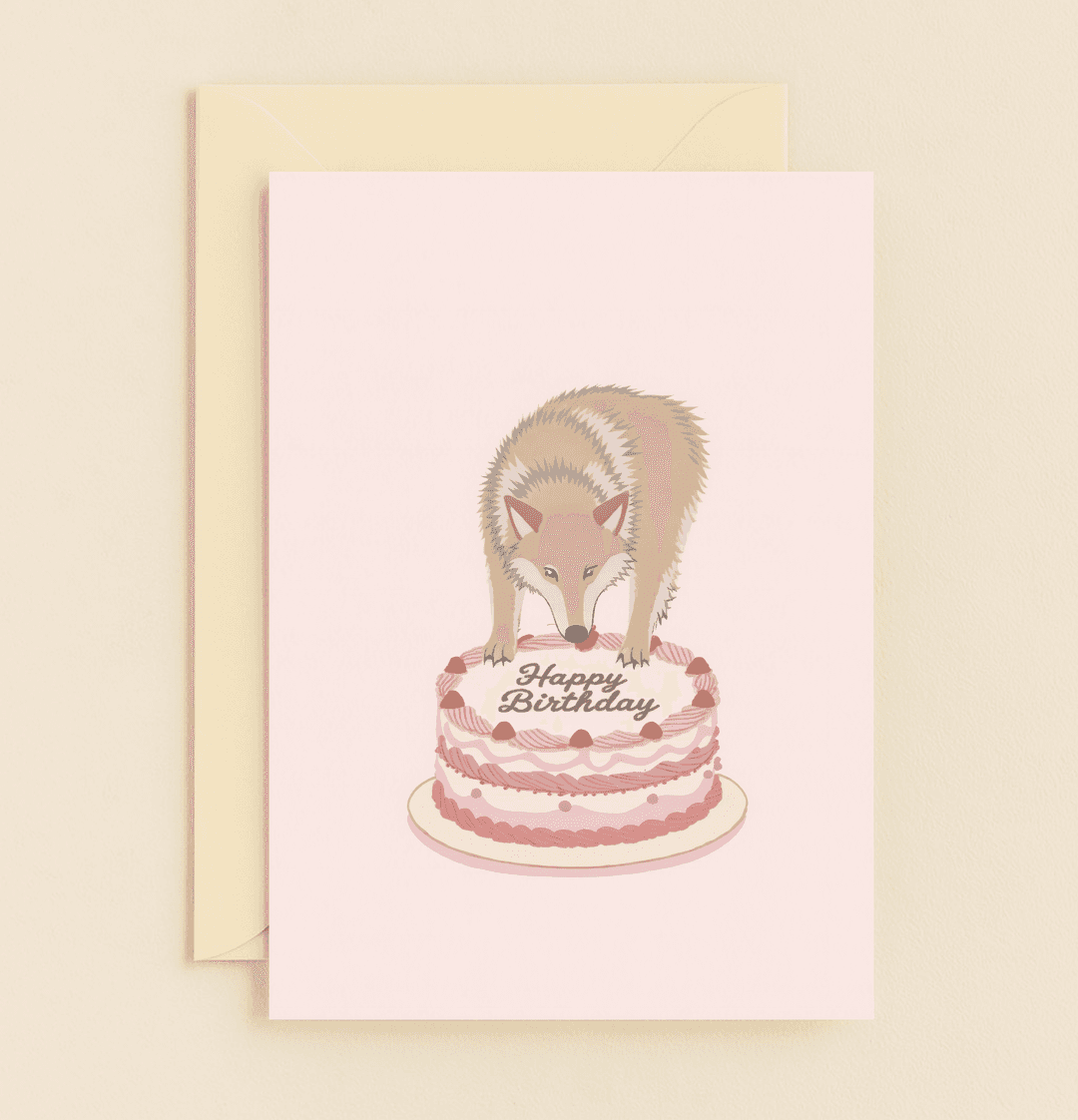 Send wildly fun birthday wishes with this absurdly humorous card featuring a curious wolf atop a pink-frosted cake.