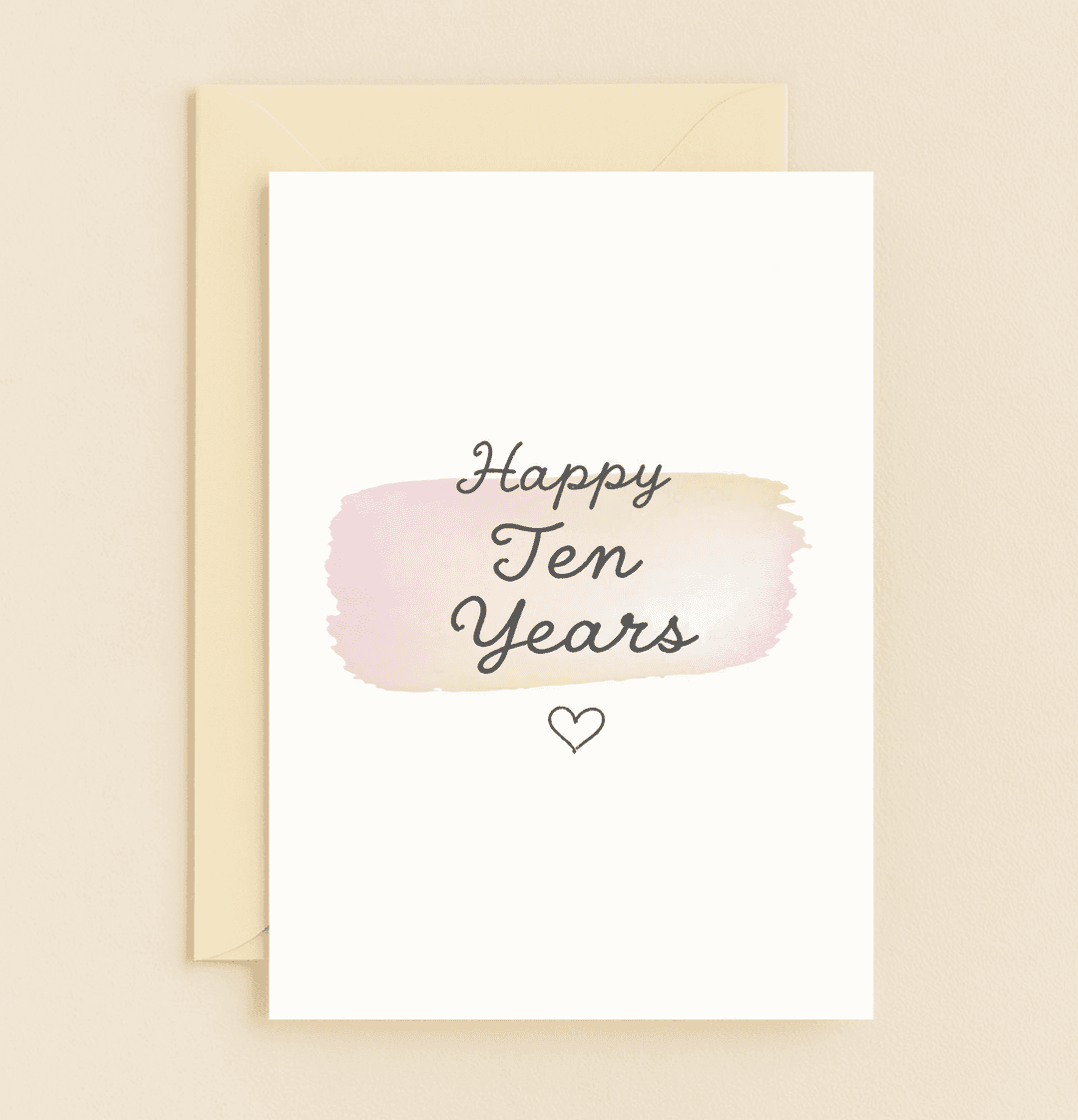 Celebrate ten years of love with this elegant anniversary card featuring a heartfelt script on a soft watercolor backdrop and a charming heart outline.