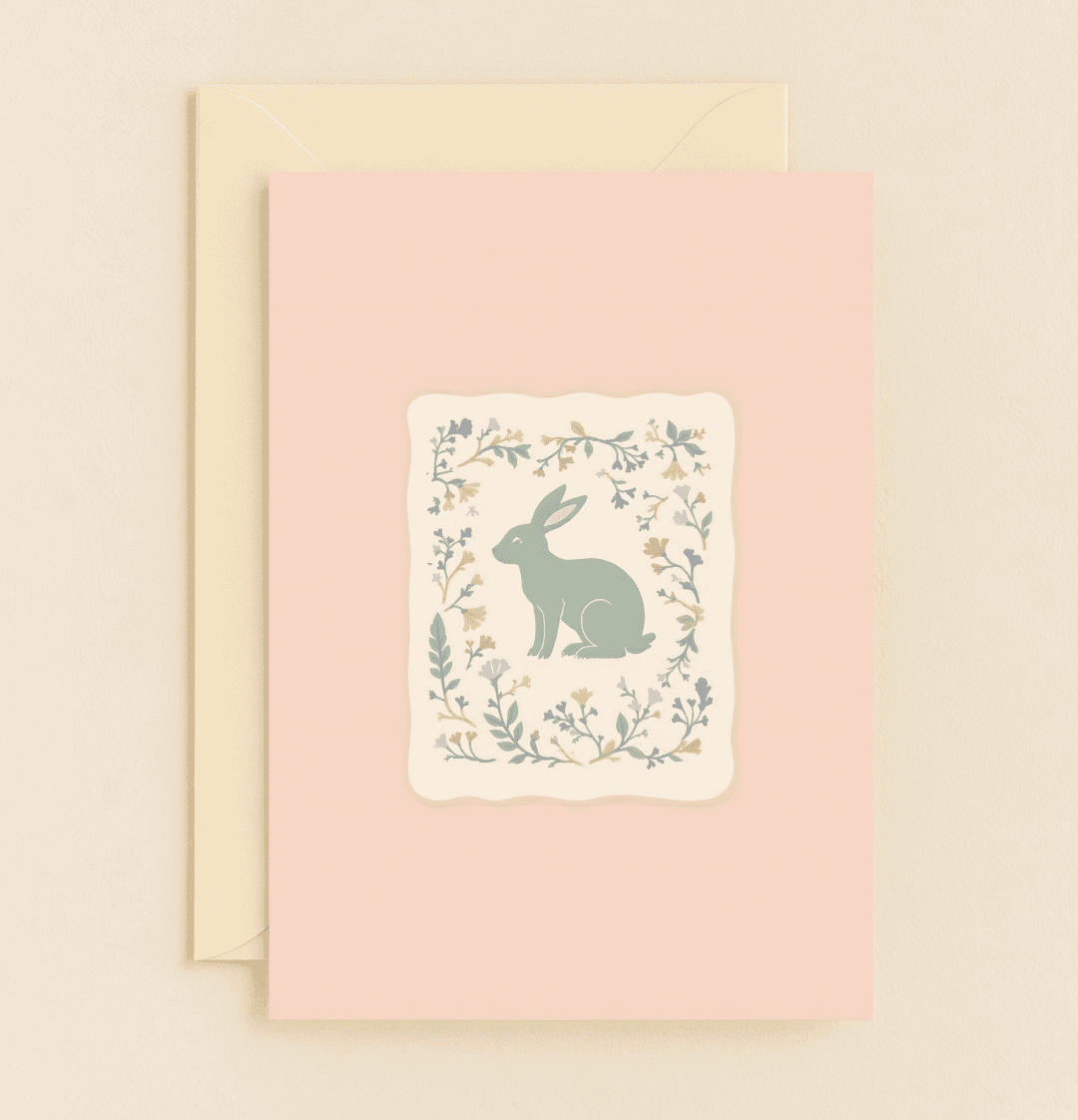 Celebrate Easter with a whimsical greeting card featuring a serene green rabbit amid pastel floral designs on a soothing pink background.