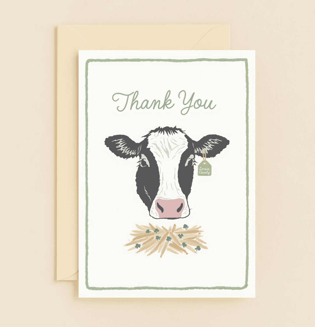 Express heartfelt thanks with "Udderly Grateful Greetings," featuring a cute cow, hay, and clovers, perfect for pun lovers from Lorain County.