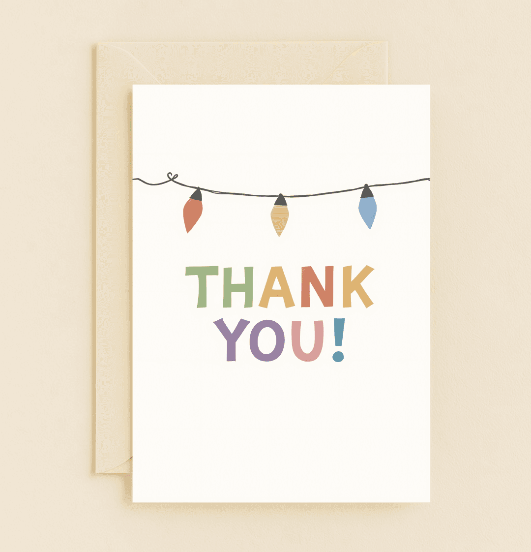 Express gratitude with the "Bright Lights, Big Gratitude" card, featuring colorful letters and festive holiday lights for a cheerful thank you celebration.