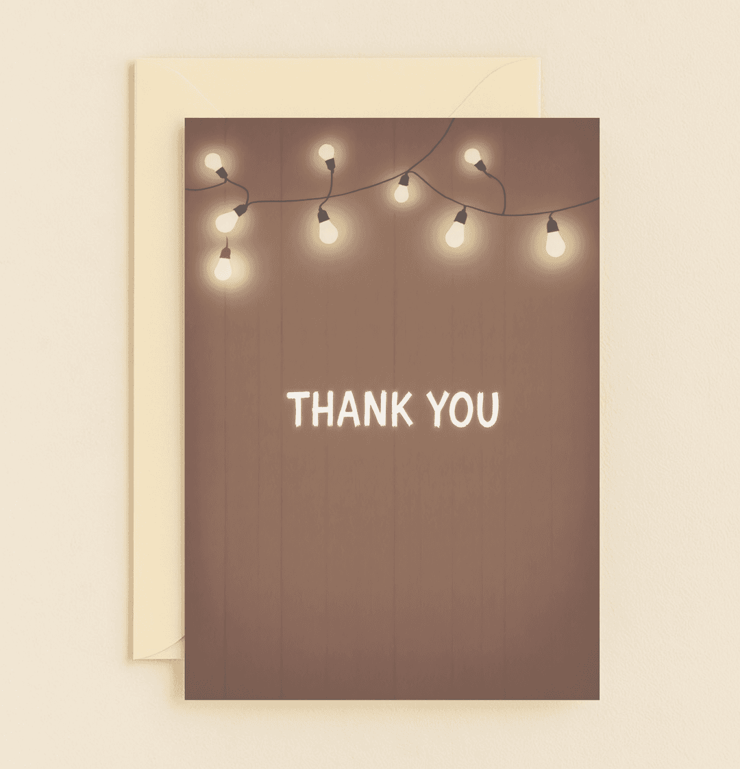 Express gratitude with our "Warm Thanks Under Twinkling Lights" card, featuring rustic string lights and a heartfelt thank you on a charming brown backdrop.