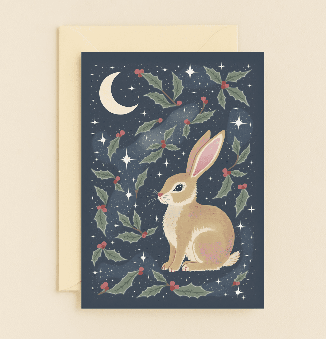 Celebrate Easter with "Moonlit Magic: A Bunny's Night," featuring a whimsical rabbit stargazing under a crescent moon with festive holly and berries.