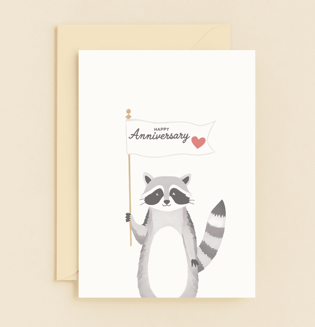 Celebrate your love with a charming anniversary card featuring an adorable raccoon holding a heartfelt flag.