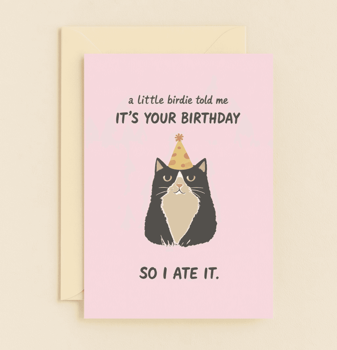 Celebrate with a chuckle using this playful cat-themed birthday card featuring a punny surprise and a cute feline in a party hat against a pink backdrop.