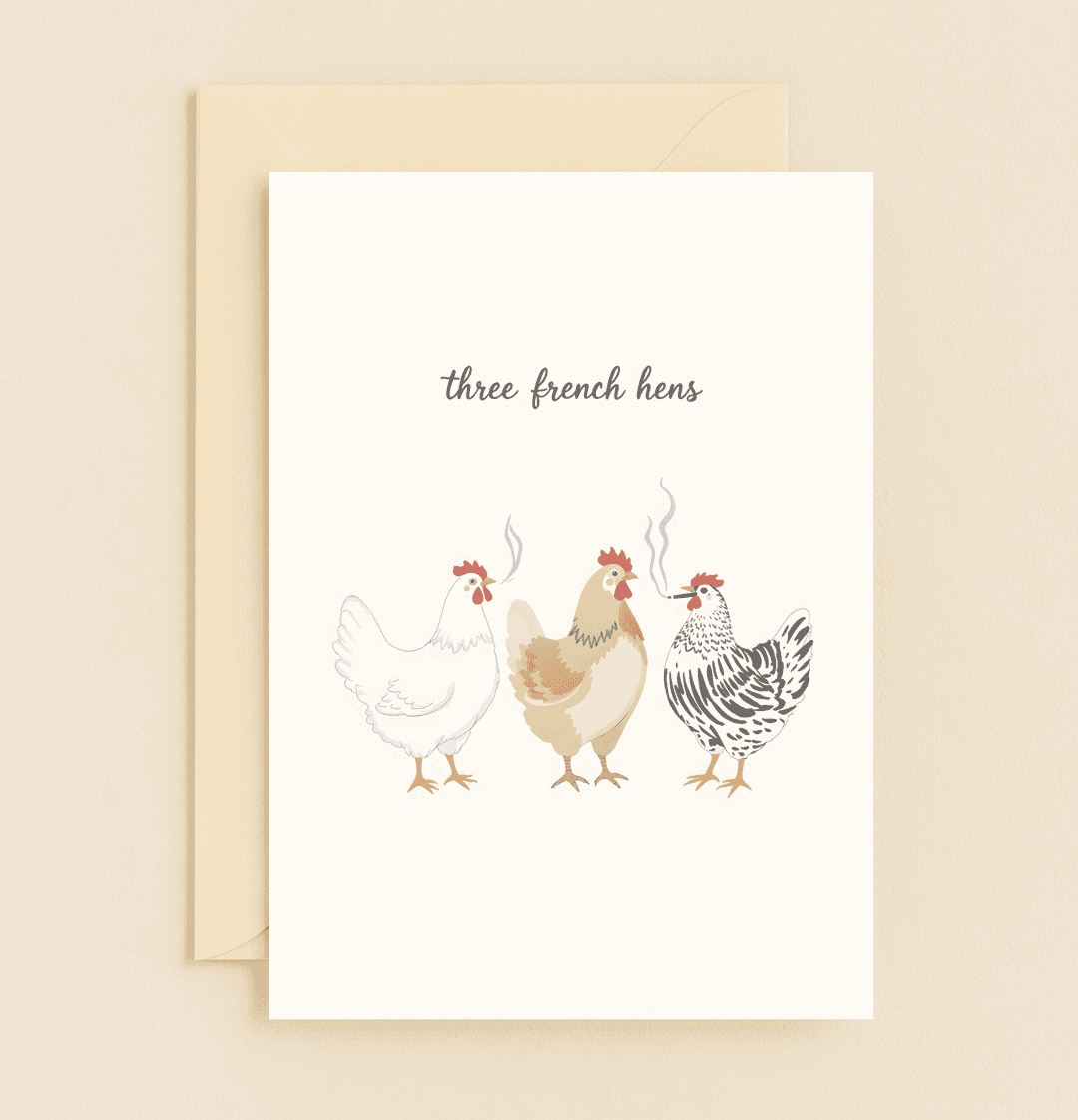 Celebrate the holidays with a cheeky twist on tradition featuring three chic French hens puffing away in this whimsical Christmas card.