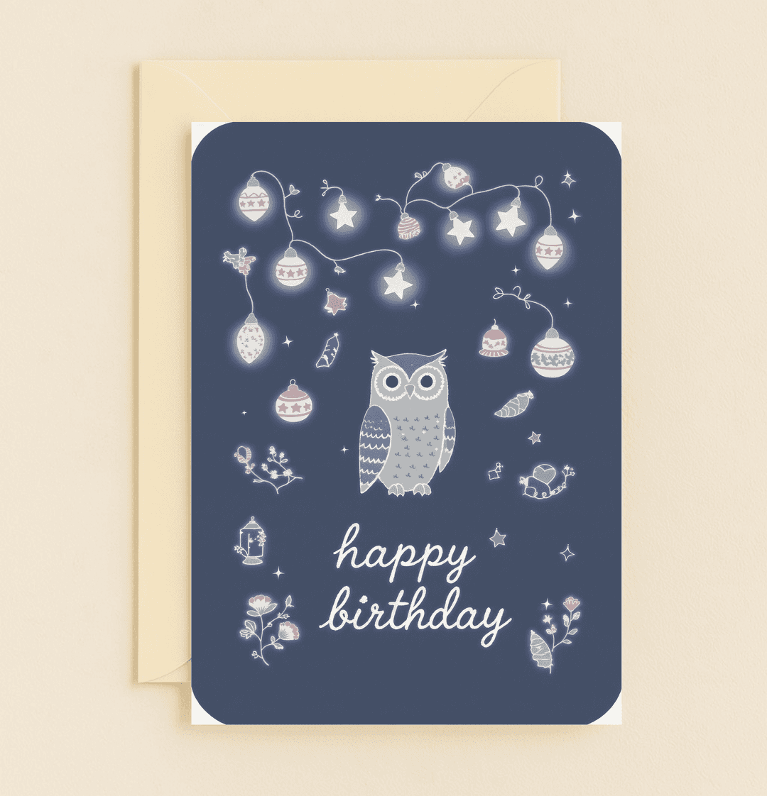 Celebrate a birthday with enchanting wishes featuring a whimsical owl amidst twinkling stars and festive baubles on a dark blue backdrop.