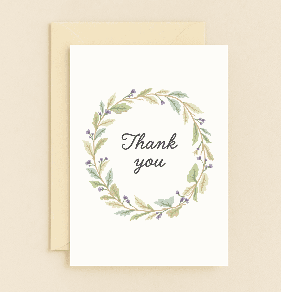 Express your gratitude with "Grateful Blossoms," a pastel card featuring a graceful wreath of green and purple branches encircling a heartfelt "Thank You.
