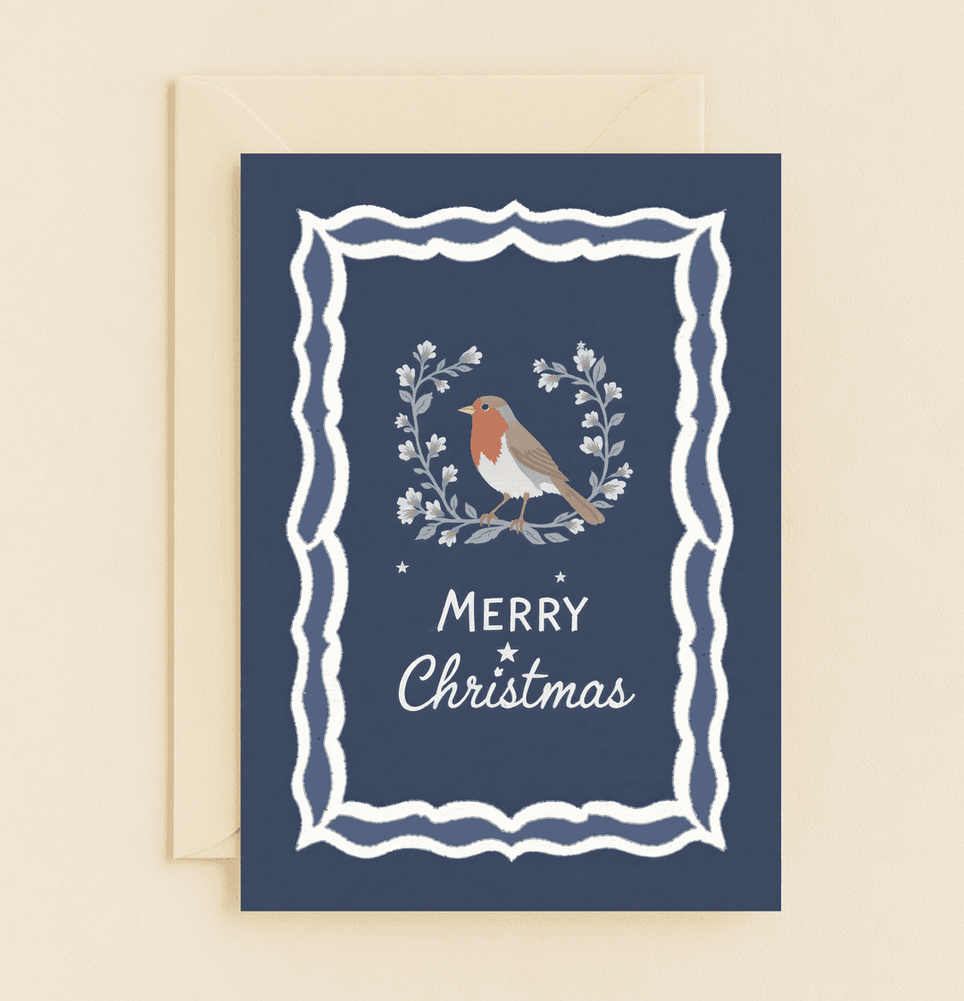 Celebrate Christmas with "Robin's Festive Cheer," featuring a robin in a floral wreath on a deep blue card, perfect for a warm, nature-inspired holiday message.