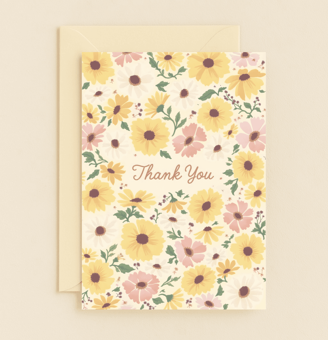Express heartfelt thanks with the Blossom of Gratitude card, featuring elegant script and a pastel floral design of daisies and sunflowers on a cream background.