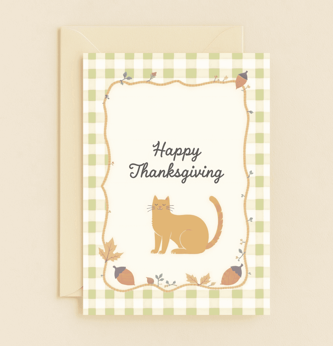 Send warm Thanksgiving cheer with this charming card featuring a cozy cat, autumn leaves, and acorns on a soft green gingham background.