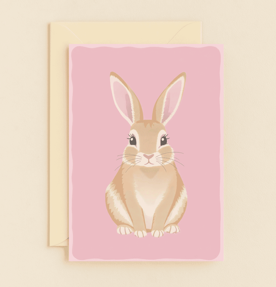 Celebrate Easter with a whimsical card featuring an adorable bunny on a pink background, perfect for spreading joy and springtime cheer.