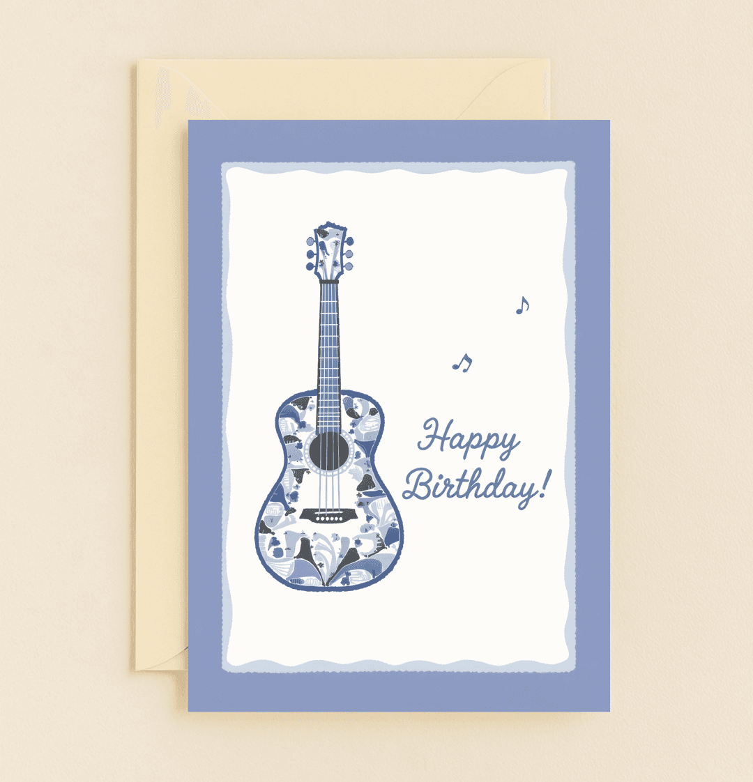 Celebrate a musical birthday with this handcrafted card featuring a blue guitar adorned with floral patterns and scattered musical notes.