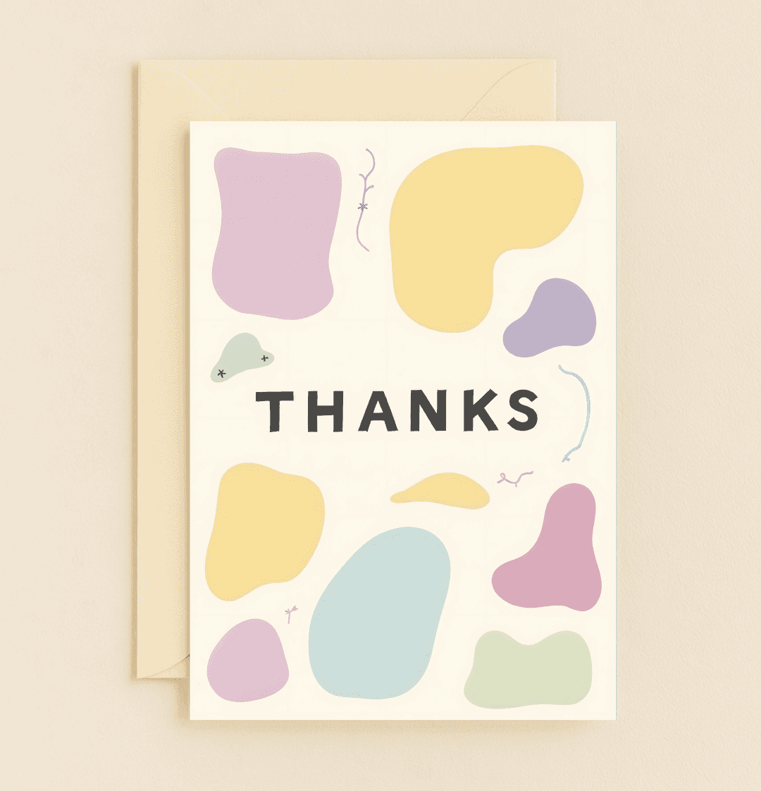 Express your gratitude with a modern, minimalist greeting card featuring bold "THANKS" surrounded by playful pastel abstract shapes on a soft cream background.