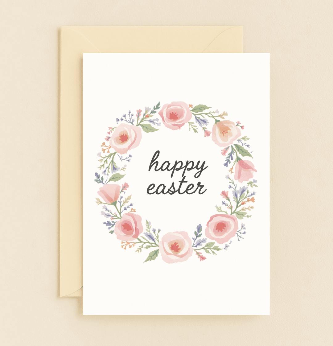 Celebrate Easter with a "Blooming Easter Greetings" card featuring a delicate floral wreath and elegant handwritten text, perfect for spring celebrations.