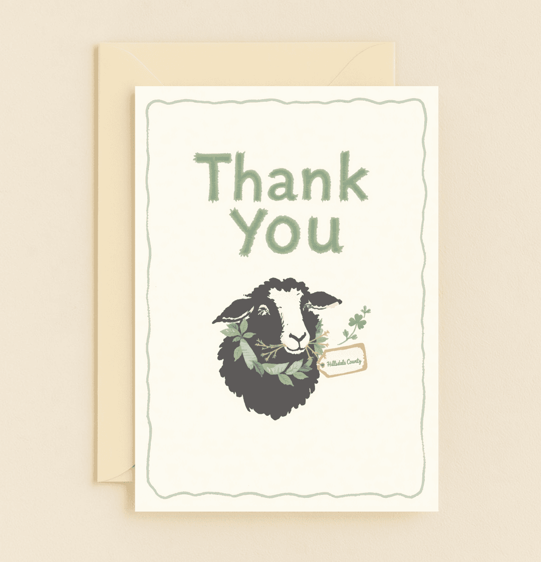 Send heartfelt thanks with a touch of humor through this charming Hillsdale County card, featuring a wreath-adorned sheep and playful green accents.