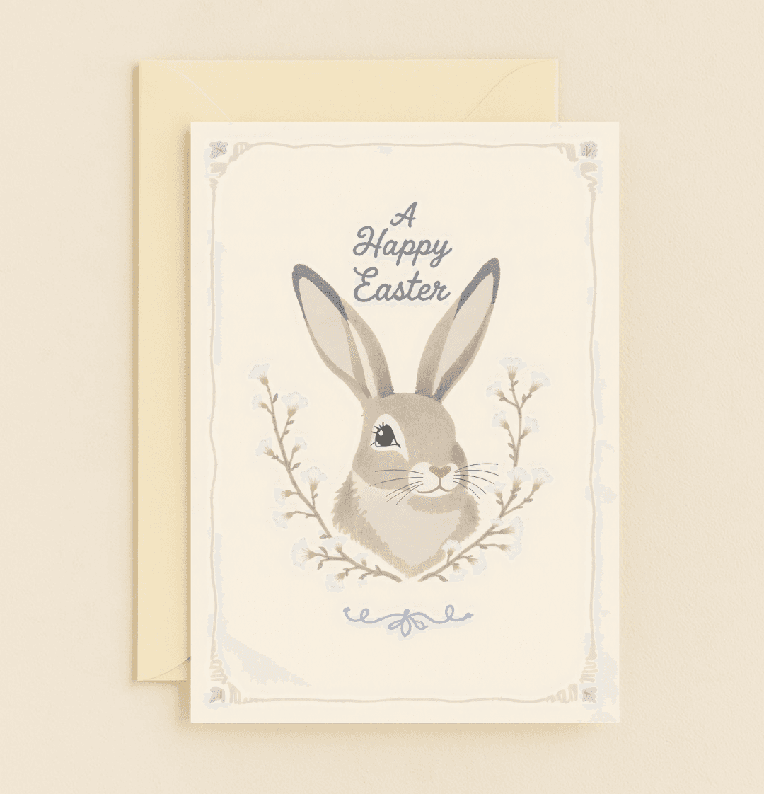 Celebrate Easter with a whimsical card featuring a charming bunny amidst delicate flowers, perfect for spreading joy and springtime cheer.