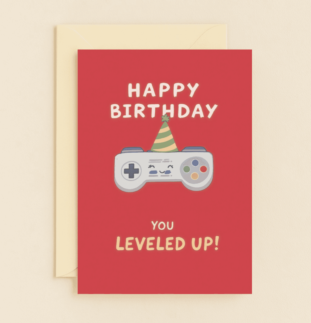 Celebrate a gamer's birthday with this vibrant card featuring a playful game controller in a party hat, perfect for leveling up the birthday fun with puns!.