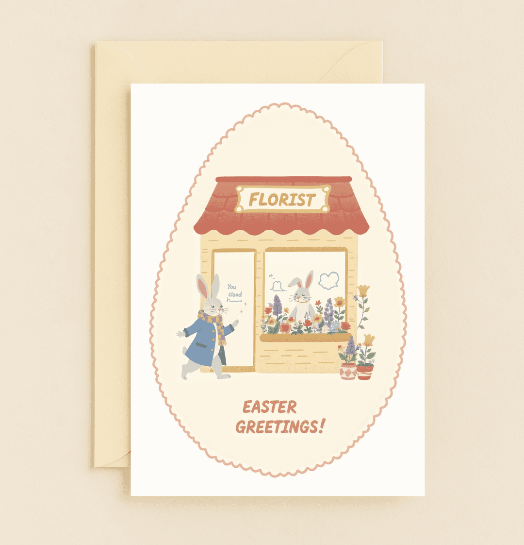 Delight in Easter cheer with this egg-shaped card featuring a charming bunny in a blue coat, enjoying a floral reflection and playful wordplay.