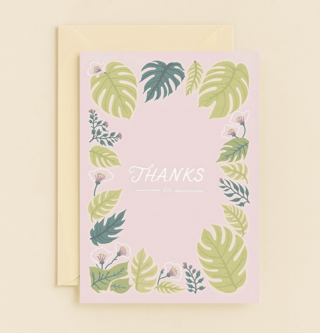 Express heartfelt gratitude with this elegant thank you card featuring tropical leaves and delicate flowers on a pastel pink background.