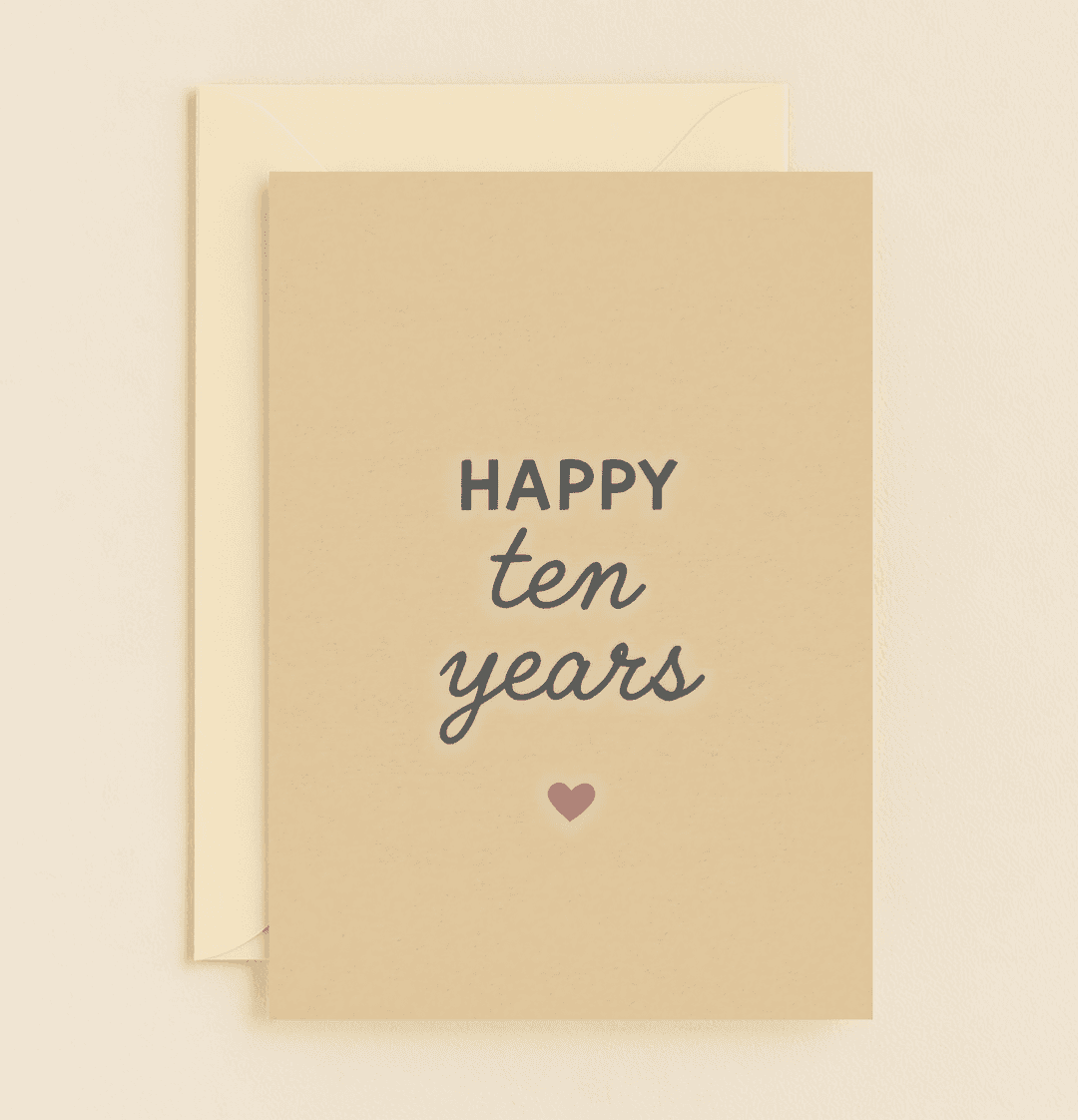 Celebrate ten years of love with this minimalist anniversary card, featuring elegant typography and a heartfelt red heart on a light beige background.