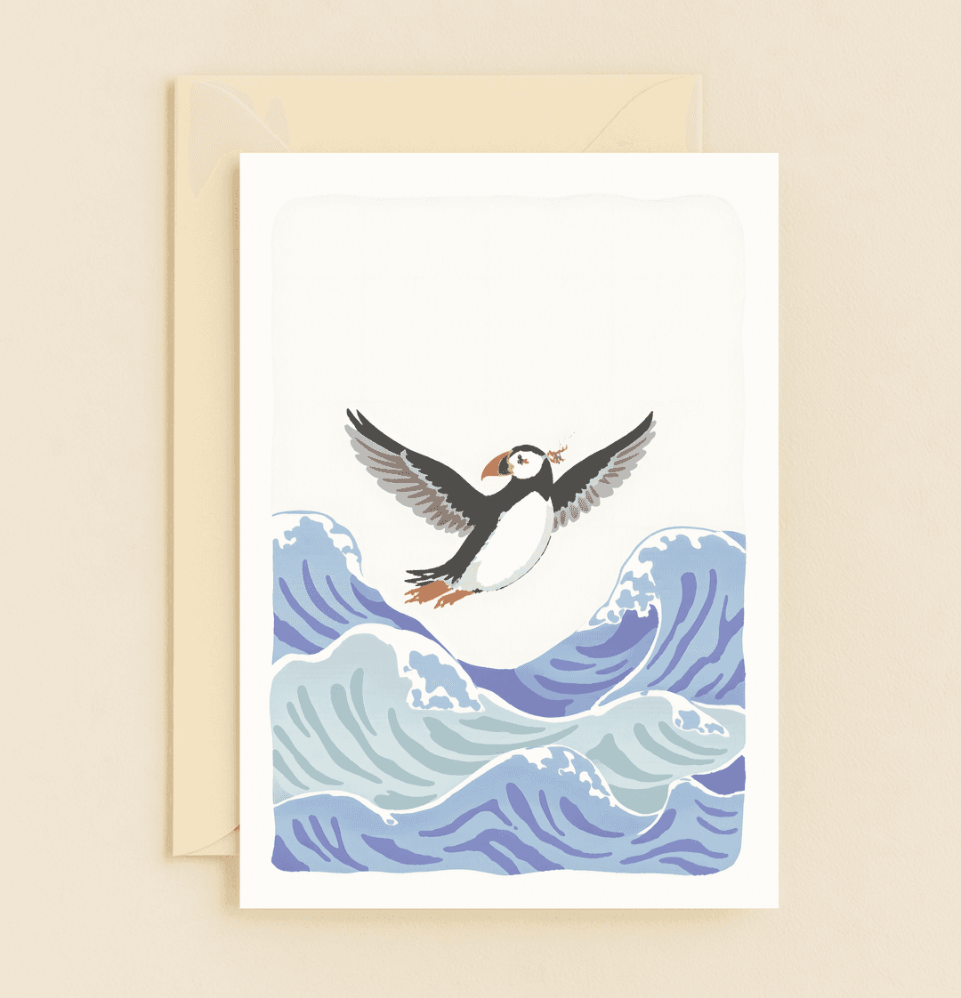 Celebrate Father's Day with "Soaring High: Celebrating You," a card featuring a puffin in flight over ocean waves, symbolizing adventure and freedom.