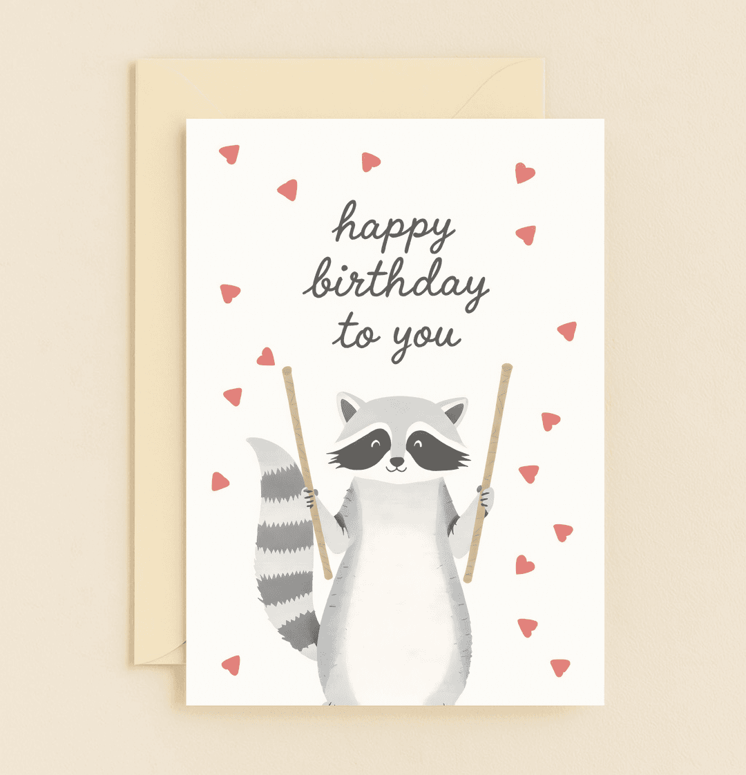Celebrate with a whimsical raccoon drumming up birthday joy amidst hearts and delight, perfect for spreading cheerful vibes.